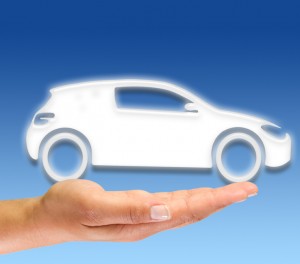 Car icon held in the palm of a hand